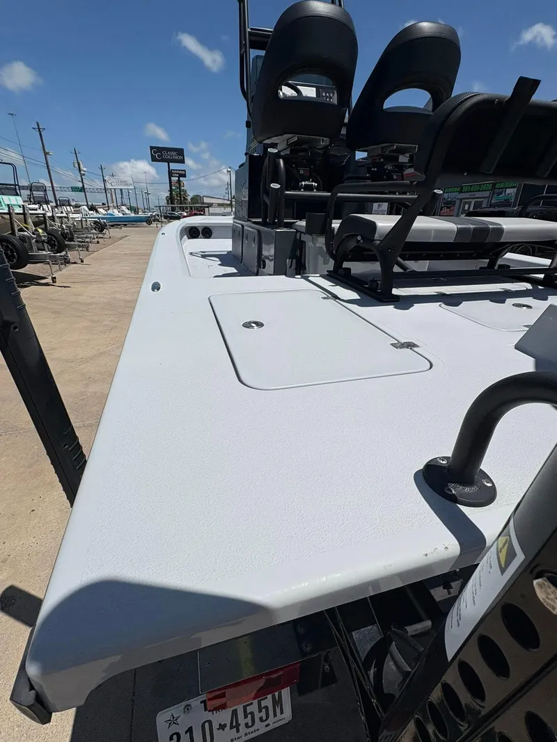 Slide: The Image of 2022 JH Performance Outlaw 250 boat, showcasing deck and seating, under clear blue sky. - 16