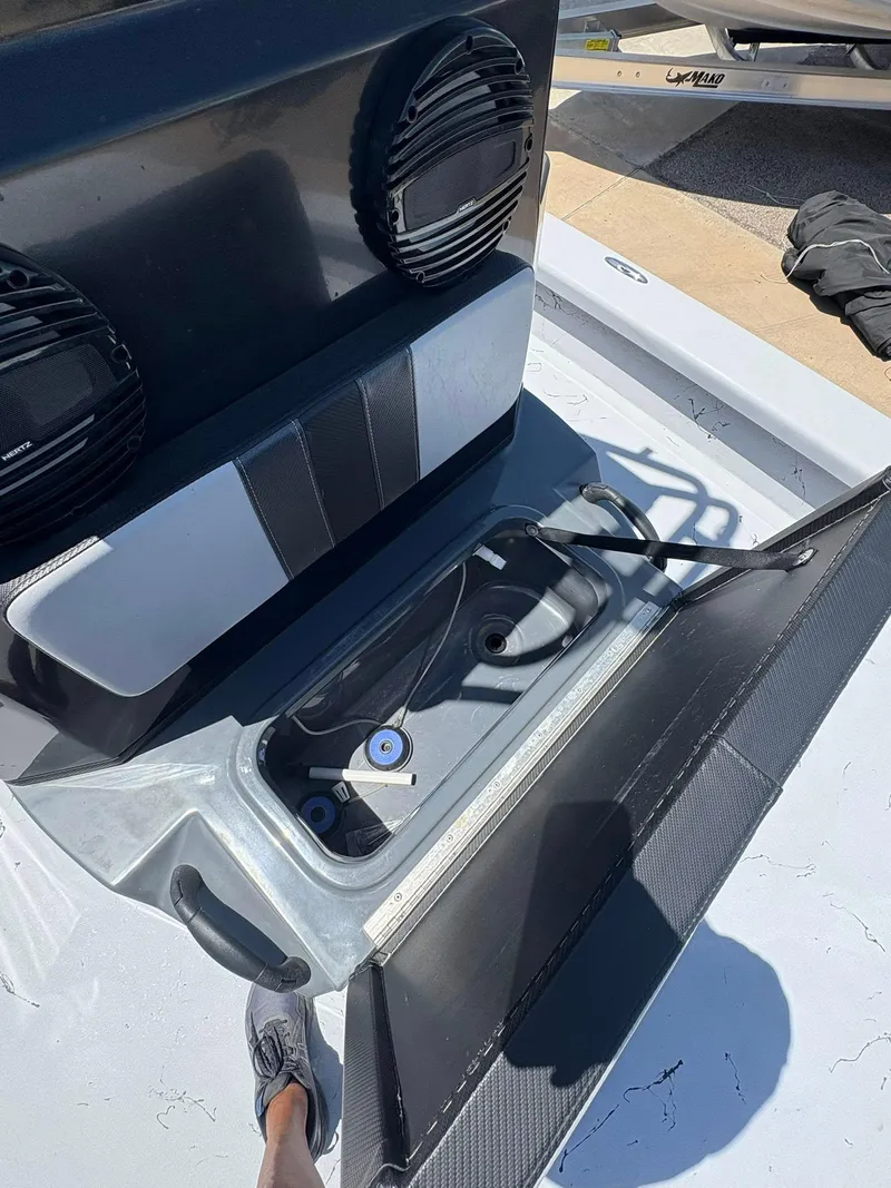 Slide: The Image of 2022 JH Performance Outlaw 250 boat storage compartment with speakers and open hatch. - 18