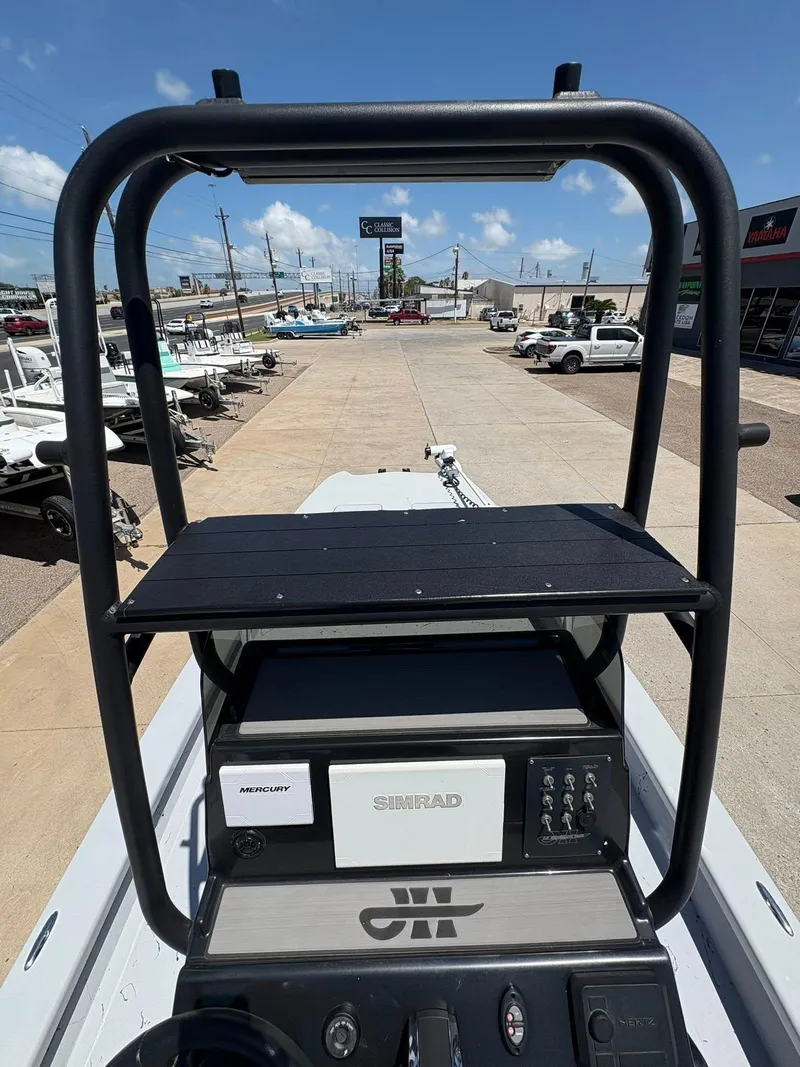 Slide: The Image of 2022 JH Performance Outlaw 250 boat console with Simrad and Mercury equipment, parked outdoors. - 19