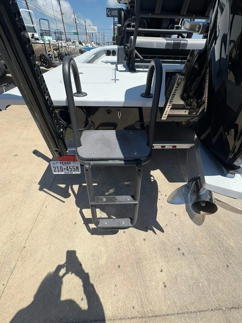 Slide: The Image of 2022 JH Performance Outlaw 250 boat with ladder and Texas license plate. - 22