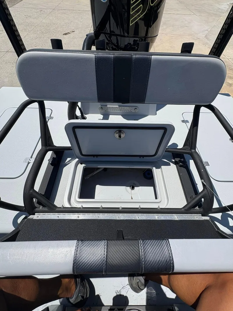 Slide: The Image of 2022 JH Performance Outlaw 250 boat interior with open storage compartment and seating. - 4