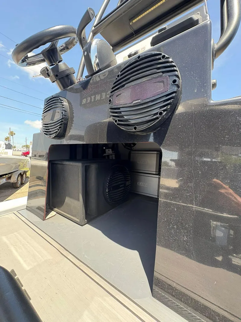 Slide: The Image of 2022 JH Performance Outlaw 250 boat console with speakers and steering wheel. - 5