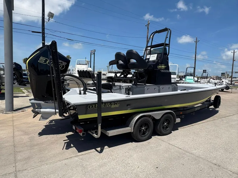Slide: The Image of 2022 JH Performance Outlaw 250 boat on trailer, parked outdoors under clear sky. - 7