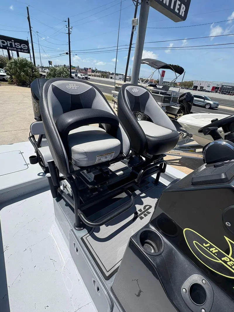 Slide: The Image of 2022 JH Performance Outlaw 250 boat seats and console in a dealership lot. - 8