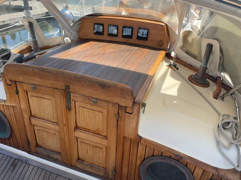 Slide: The Image of 1985 Hans Christian 33T sailboat cockpit with wooden hatch and navigation instruments. - 13