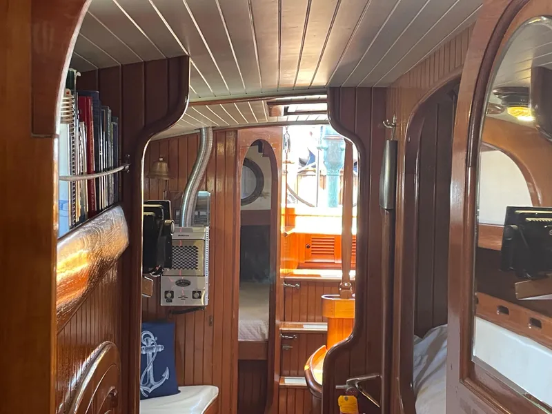 Slide: The Image of Interior of 1985 Hans Christian 33T sailboat with wooden paneling and nautical decor. - 19