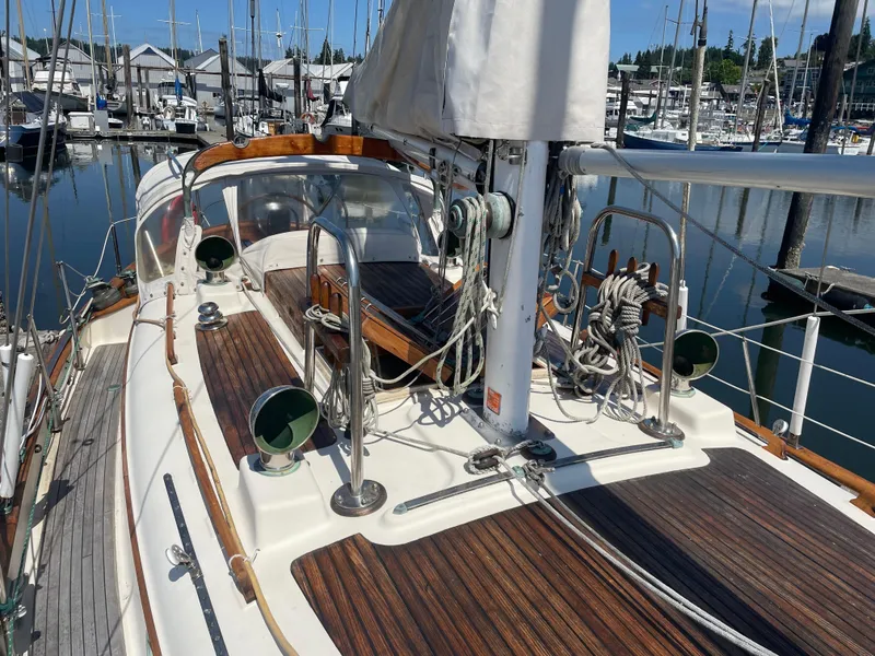 Slide: The Image of 1985 Hans Christian 33T sailboat deck with wooden finish, docked in a marina. - 2