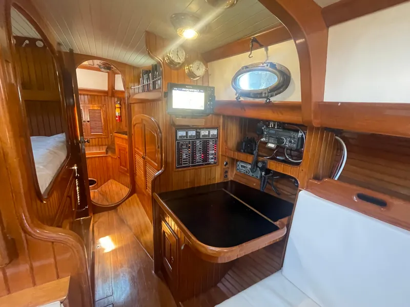 Slide: The Image of Interior of 1985 Hans Christian 33T sailboat with wooden paneling and navigation equipment. - 20