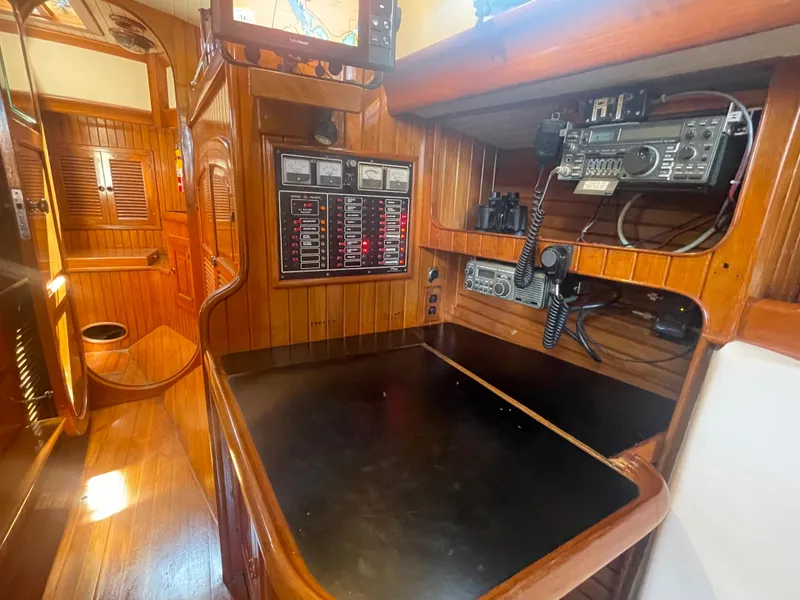 Slide: The Image of 1985 Hans Christian 33T yacht interior with navigation equipment and wooden paneling. - 22