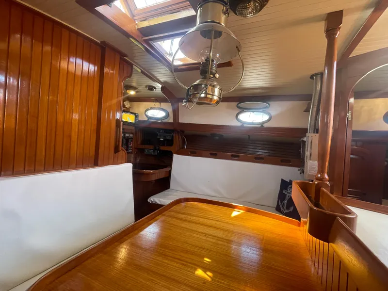 Slide: The Image of Interior of 1985 Hans Christian 33T sailboat with wooden finishes and cozy seating area. - 26
