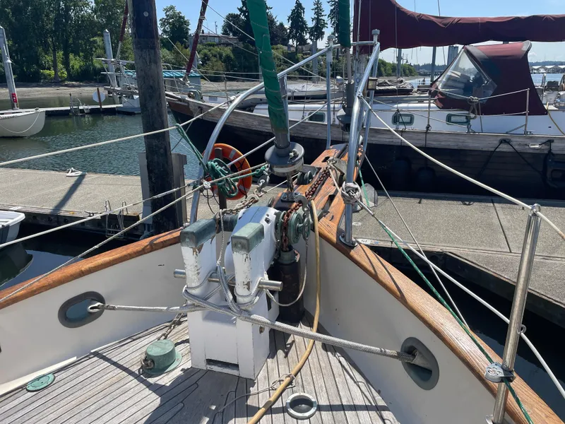 Slide: The Image of 1985 Hans Christian 33T sailboat deck with winches and ropes at marina. - 29