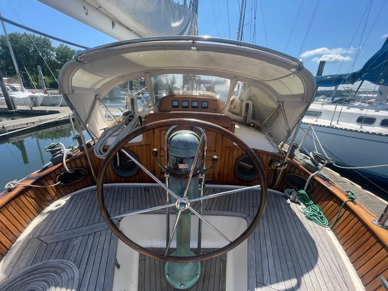 Slide: The Image of Cockpit of a 1985 Hans Christian 33T sailboat with wooden details and steering wheel. - 5