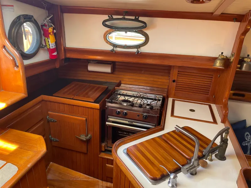 Slide: The Image of Interior of 1985 Hans Christian 33T sailboat galley with wood finish and stove. - 9