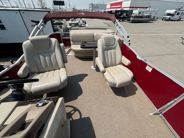 Slide: The Image of 2012 Bennington R25 pontoon boat interior with beige seating and red accents. - 13