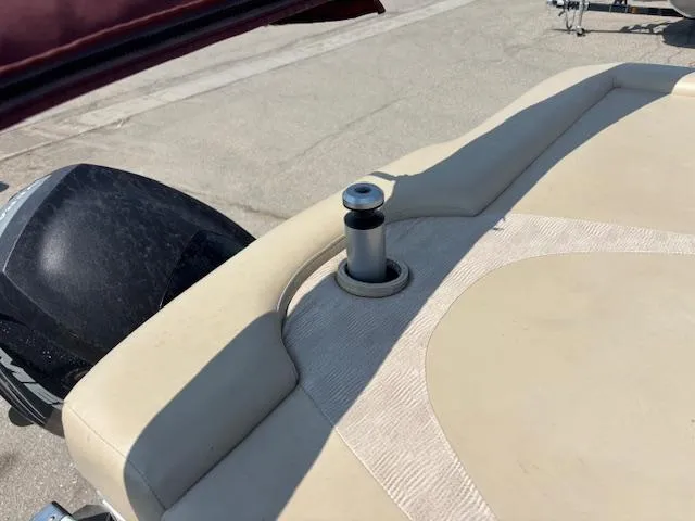 Slide: The Image of 2012 Bennington R25 boat interior with beige seating and engine detail. - 17