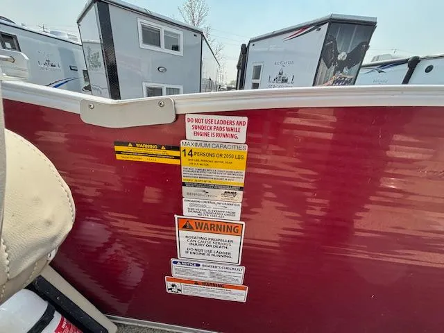 Slide: The Image of 2012 Bennington R25 boat warning labels and capacity information. - 21