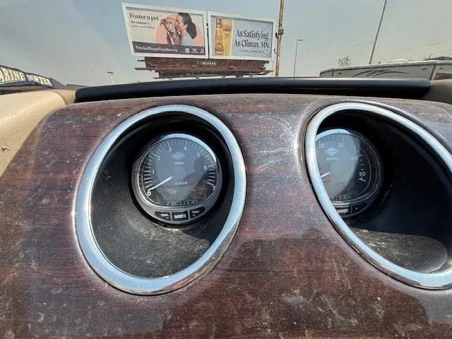 Slide: The Image of Dashboard of a 2012 Bennington R25 boat with speedometer and tachometer gauges. - 26