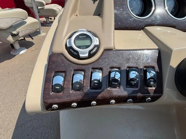 Slide: The Image of Control panel of a 2012 Bennington R25 boat with switches and a Sony audio system. - 28
