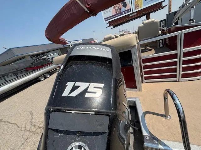 Slide: The Image of 2012 Bennington R25 boat with a 175 Verado engine, parked outdoors. - 3