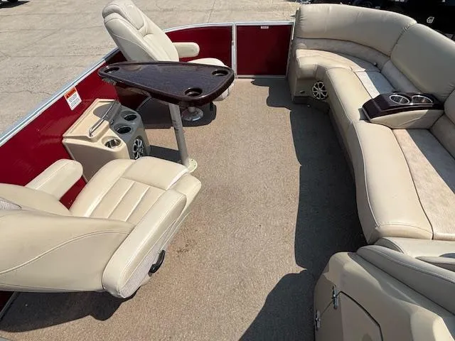 Slide: The Image of 2012 Bennington R25 boat interior with beige seating and a central table. - 31