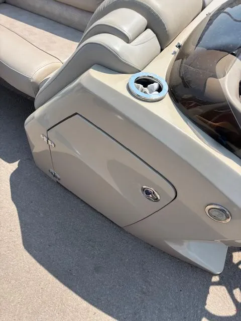 Slide: The Image of Bennington R25 2012 boat interior with beige seating and console details. - 33