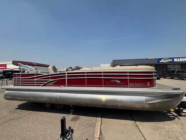 Slide: The Image of 2012 Bennington R25 pontoon boat with red and silver design on a trailer. - 5
