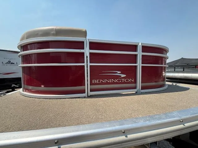 Slide: The Image of 2012 Bennington R25 pontoon boat with red exterior and beige deck. - 8