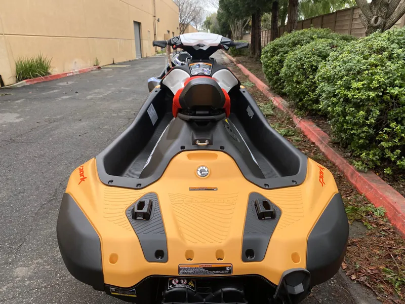 Slide: The Image of 2024 Sea-Doo Spark 2up jet ski parked on a street, rear view. - 4