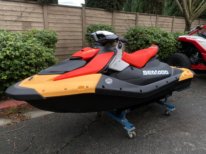 Slide: The Image of 2024 Sea-Doo Spark 2up jet ski in vibrant colors, parked outdoors. - 6
