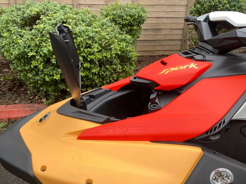 Slide: The Image of 2024 Sea-Doo Spark 2up with open storage compartment, vibrant red and yellow design. - 8