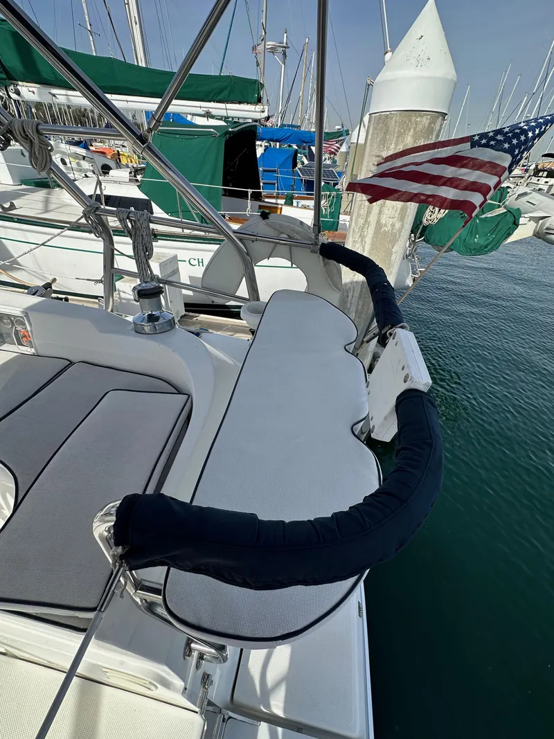 Slide: The Image of 2008 Hunter 38 sailboat deck with American flag, docked in marina. - 24