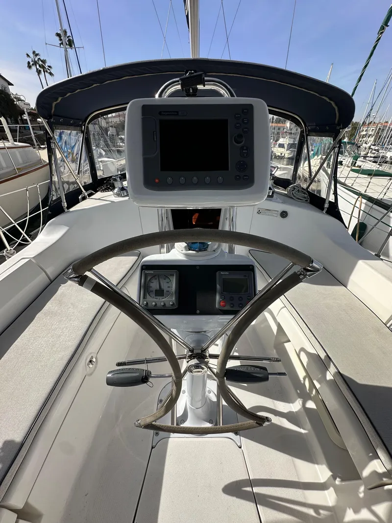 Slide: The Image of Cockpit of 2008 Hunter 38 sailboat with navigation equipment and steering wheel. - 25