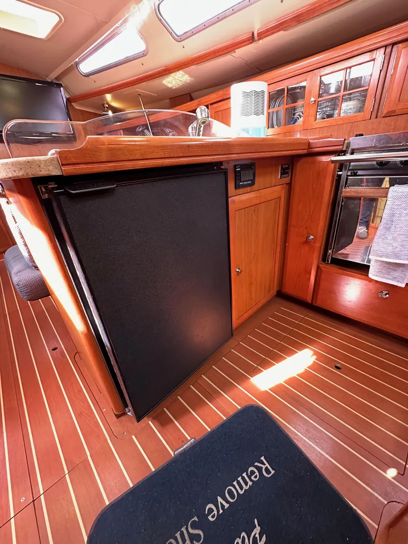 Slide: The Image of Interior of 2008 Hunter 38 sailboat kitchen with wood cabinetry and appliances. - 43