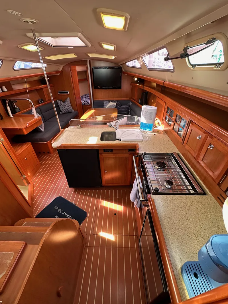 Slide: The Image of Interior of 2008 Hunter 38 sailboat with modern kitchen and cozy seating area. - 49