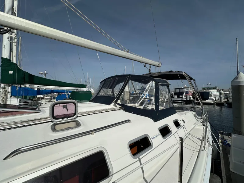 Slide: The Image of 2008 Hunter 38 sailboat docked at marina, featuring sleek design and spacious deck. - 8