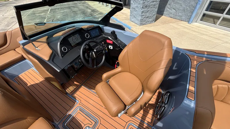 Slide: The Image of Interior of 2025 MB B52 23 Alpha boat with brown leather seating and modern dashboard. - 12