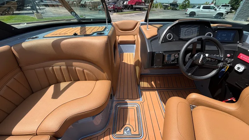 Slide: The Image of Luxurious interior of 2025 MB B52 23 Alpha boat with tan leather seating and modern dashboard. - 13