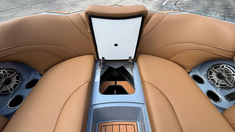 Slide: The Image of Interior of 2025 MB B52 23 Alpha boat with tan seating and storage compartment. - 18