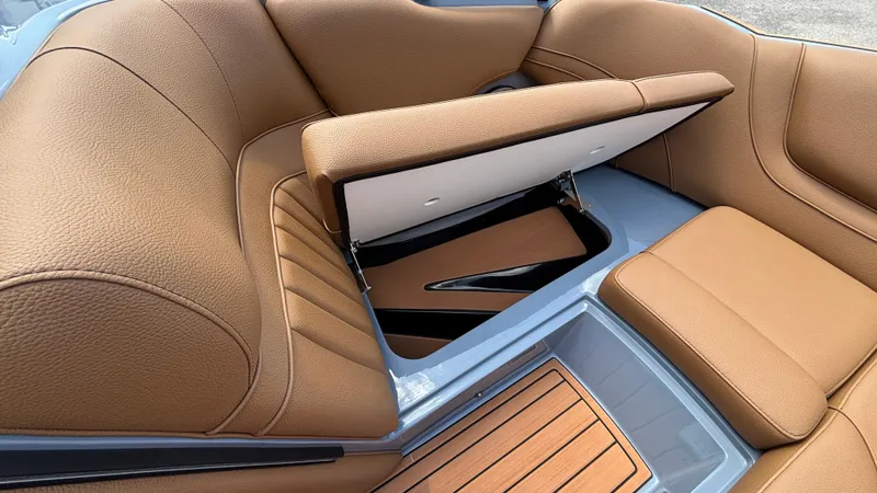 Slide: The Image of Luxurious tan leather seating with storage compartment in 2025 MB B52 23 Alpha boat. - 19