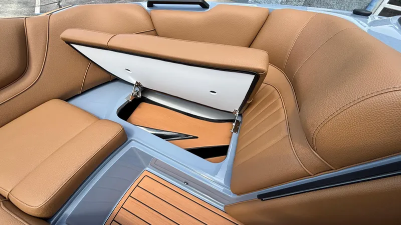 Slide: The Image of 2025 MB B52 23 Alpha boat interior with tan leather seats and storage compartment. - 20
