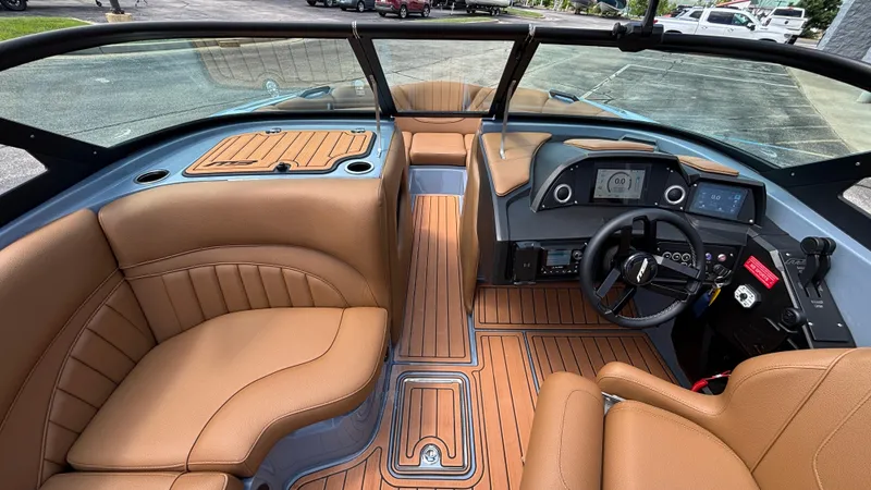 Slide: The Image of Luxurious interior of 2025 MB B52 23 Alpha boat with tan leather seating and modern dashboard. - 23