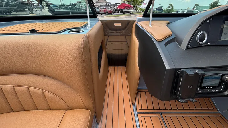 Slide: The Image of Interior of 2025 MB B52 23 Alpha boat with tan leather seats and wood flooring. - 29