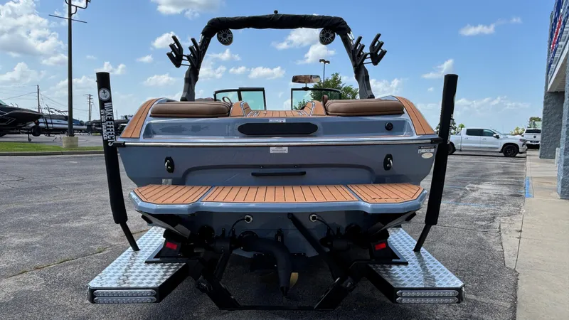 Slide: The Image of 2025 MB B52 23 Alpha boat, rear view, parked outdoors on a sunny day. - 3