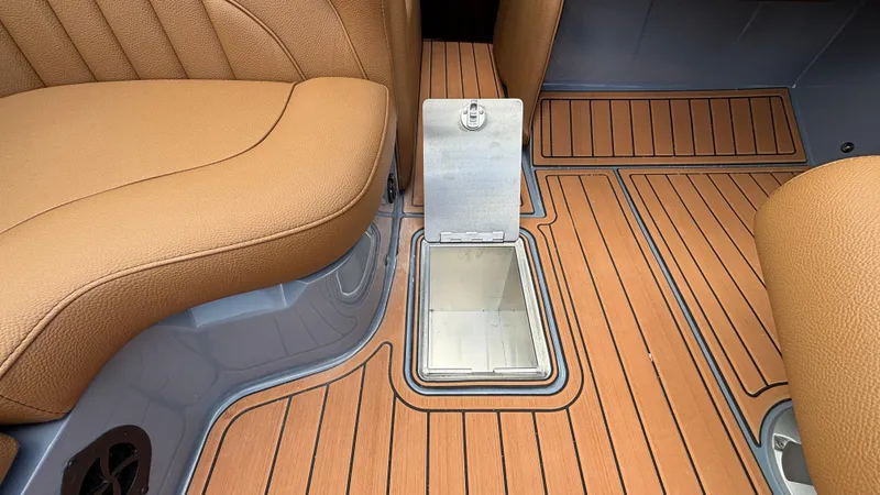 Slide: The Image of 2025 MB B52 23 Alpha interior with tan leather seats and open storage compartment. - 36