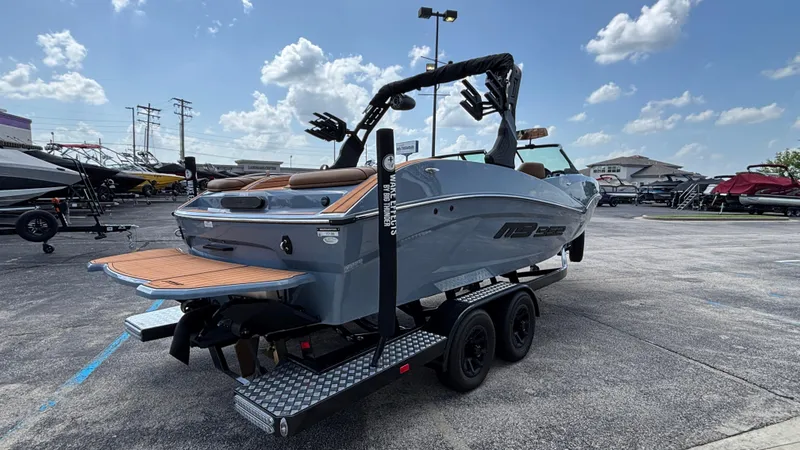 Slide: The Image of 2025 MB B52 23 Alpha boat on trailer under a clear blue sky. - 4