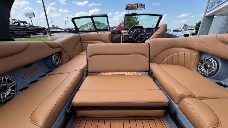 Slide: The Image of 2025 MB B52 23 Alpha boat interior with tan leather seating and modern dashboard. - 43