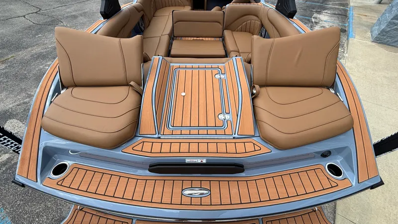 Slide: The Image of 2025 MB B52 23 Alpha boat interior with tan seating and wood accents. - 47