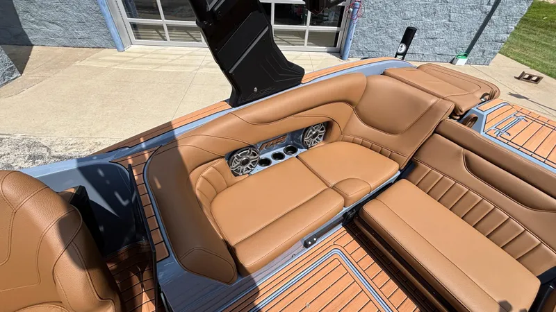 Slide: The Image of Luxurious tan leather seating in 2025 MB B52 23 Alpha boat, featuring built-in speakers. - 7