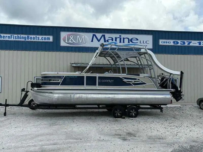 Slide: The Image of 2023 Godfrey AquaPatio 255 SDC pontoon boat on trailer at L&M Marine dealership. - 0