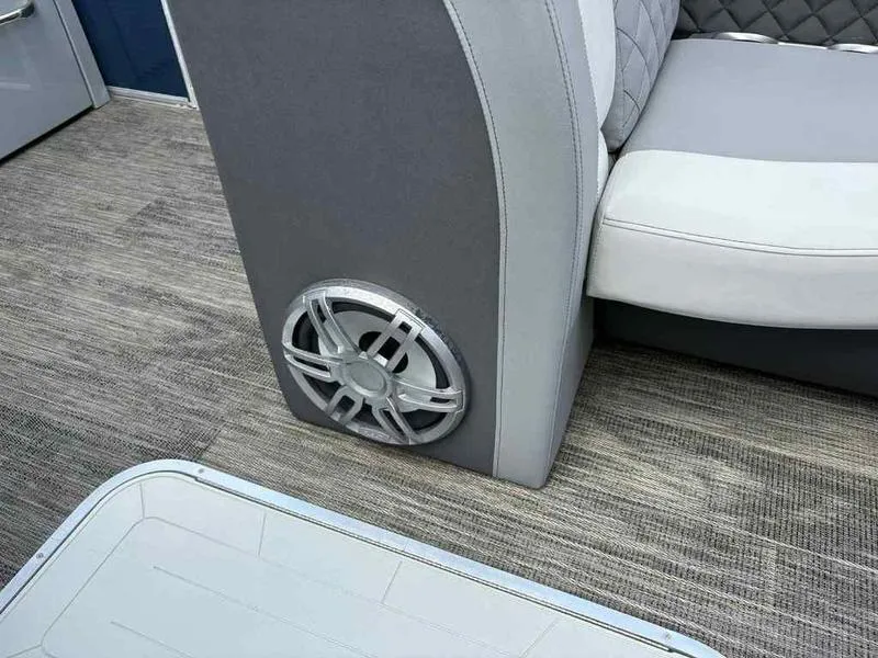 Slide: The Image of 2023 Godfrey AquaPatio 255 SDC interior with speaker and seating detail. - 10